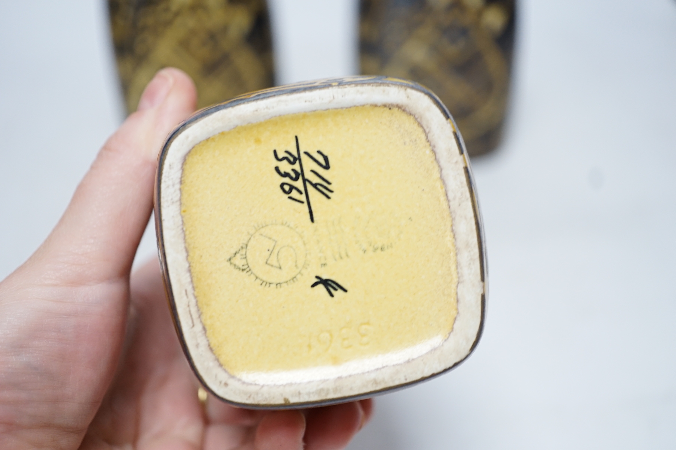 A pair of Royal Copenhagen brown and yellow decorated fajance vases marked 3208 on base and a similar bird decorated squat vase marked 3361 on base, pair of vases 18cm high
